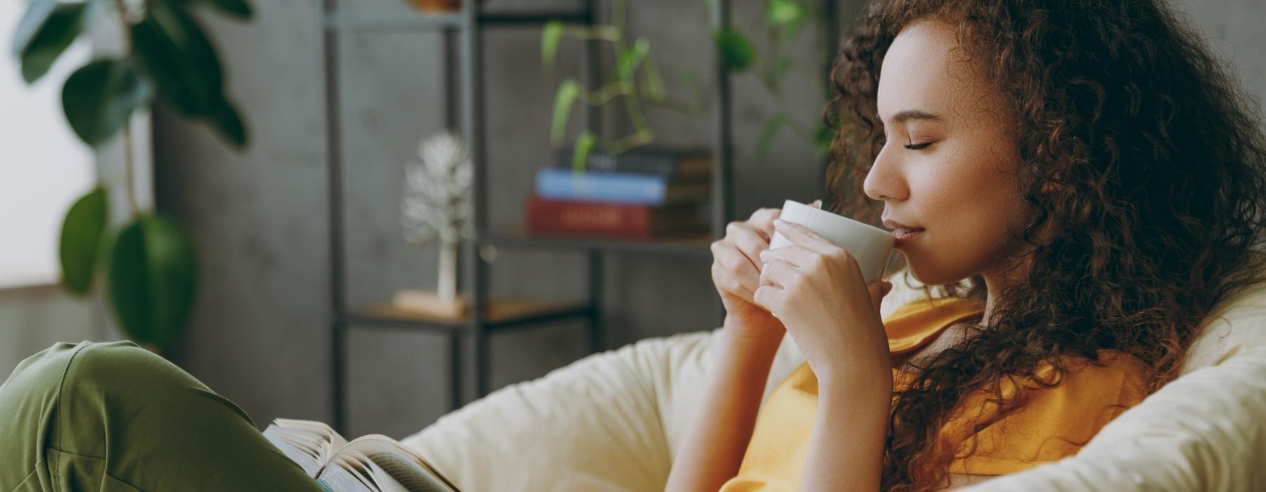 a person sitting in a chair reading a book