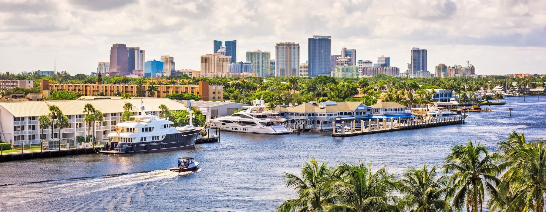 a body of water with boats and buildings in the background