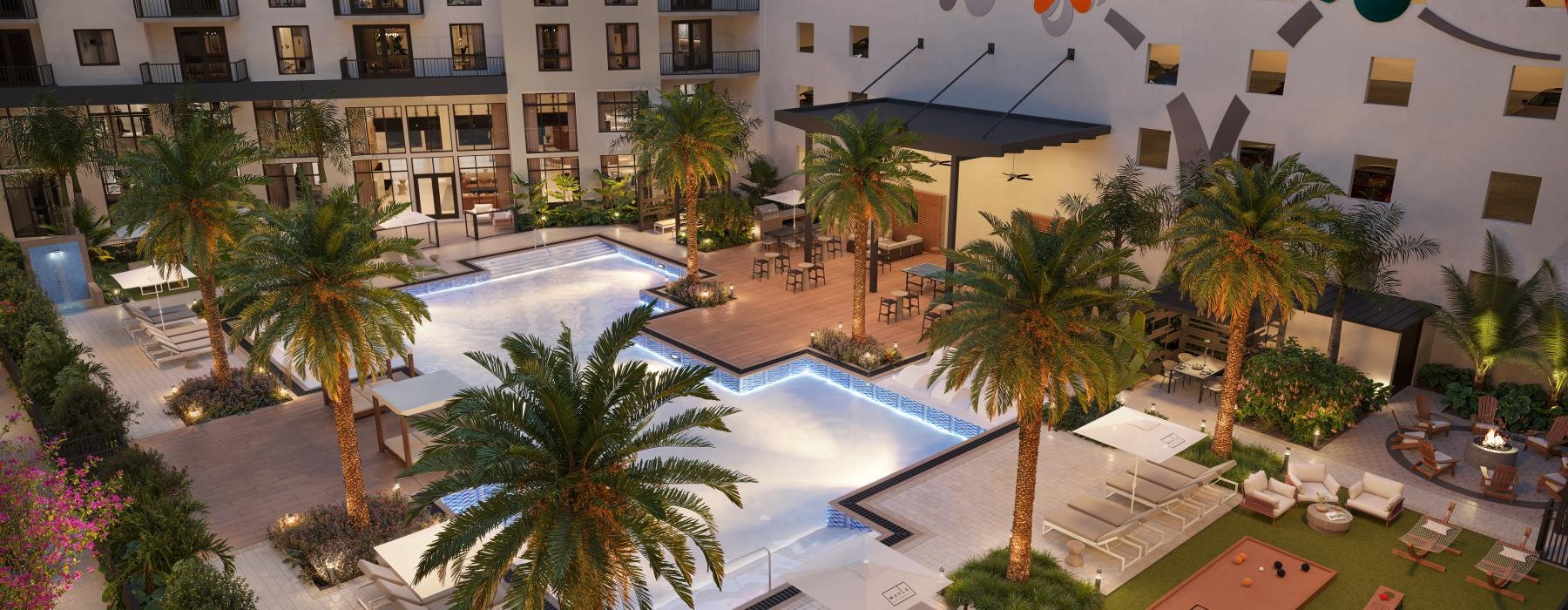 a building with palm trees and a courtyard