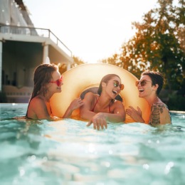 friends in a pool laughing